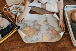 map and suitcase on the floor while preparing for your first safari